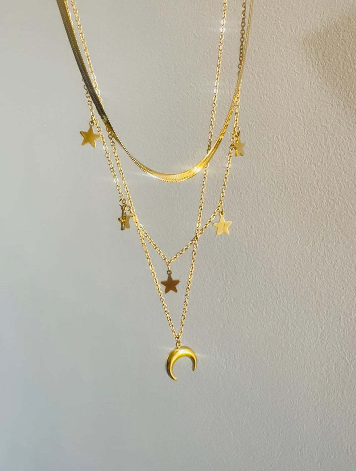 Triple Necklace featuring a snake, stars, and crescent