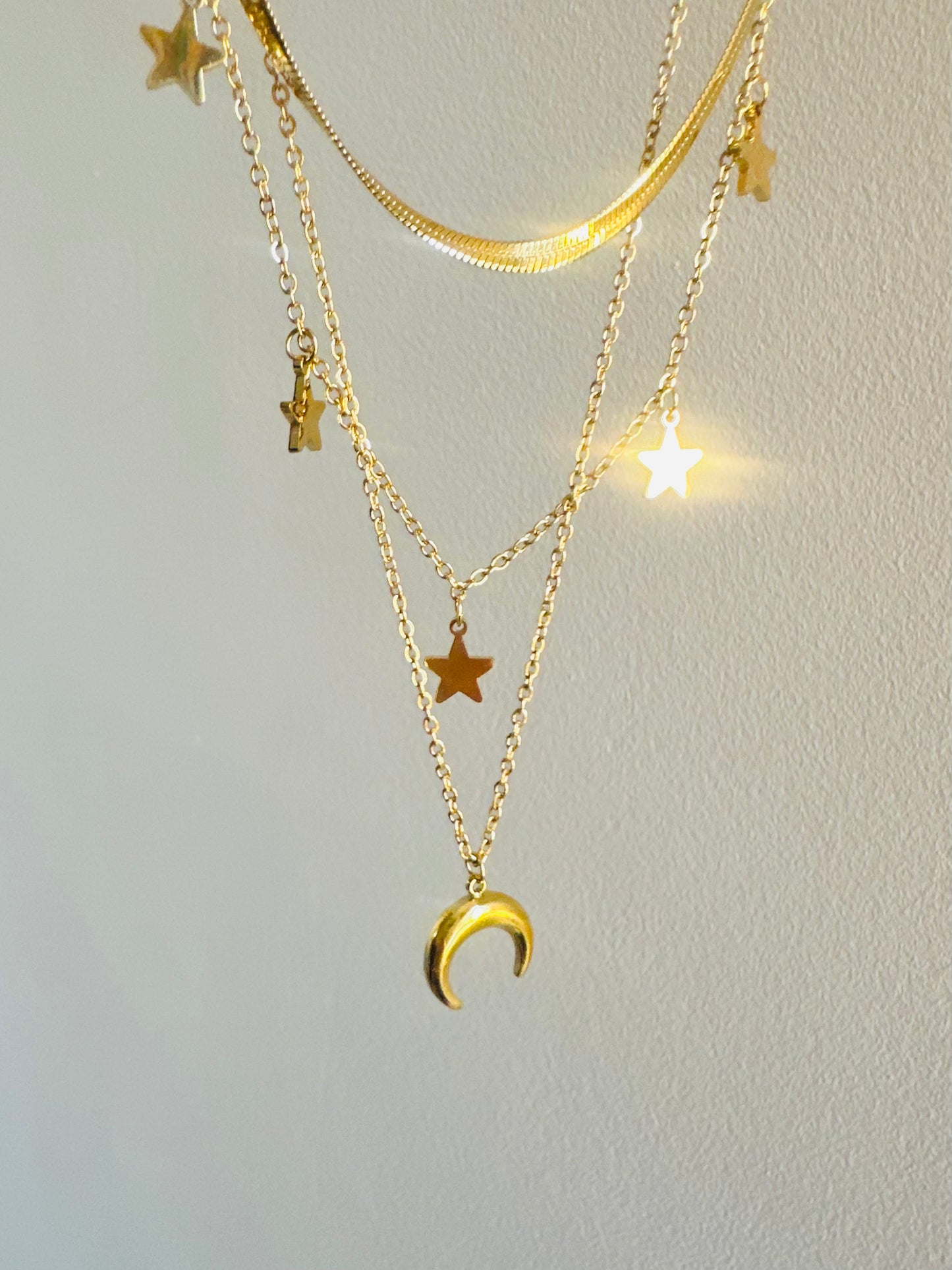 Triple Necklace featuring a snake, stars, and crescent